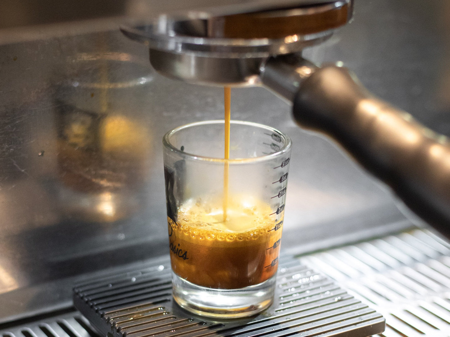 espresso machine pulling an espresso shot in a shot glass