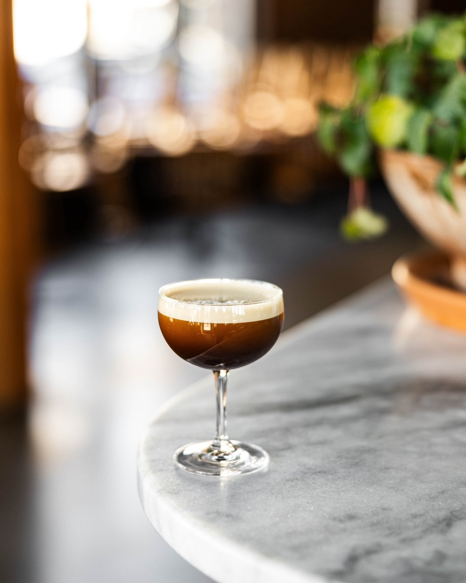 folk's espresso martini on a bar with restaurant in background