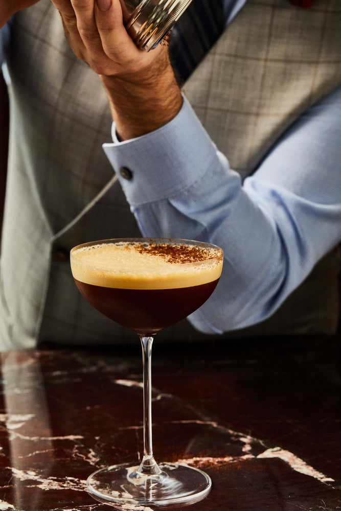 continental's espresso martini being garnished with a dash of espresso powder