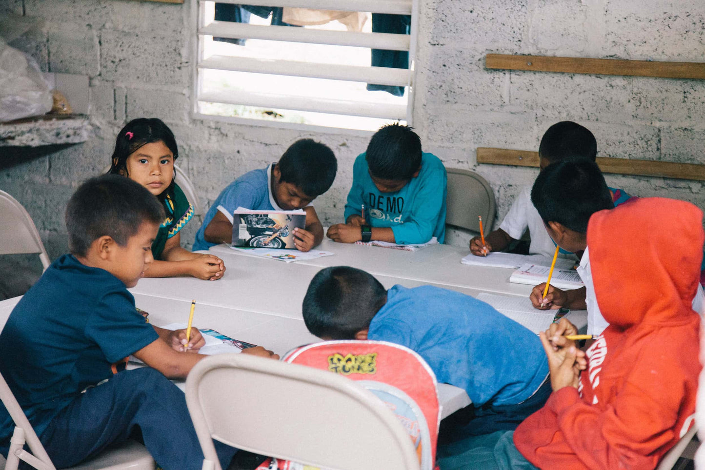 ground of students around a table at school in panama